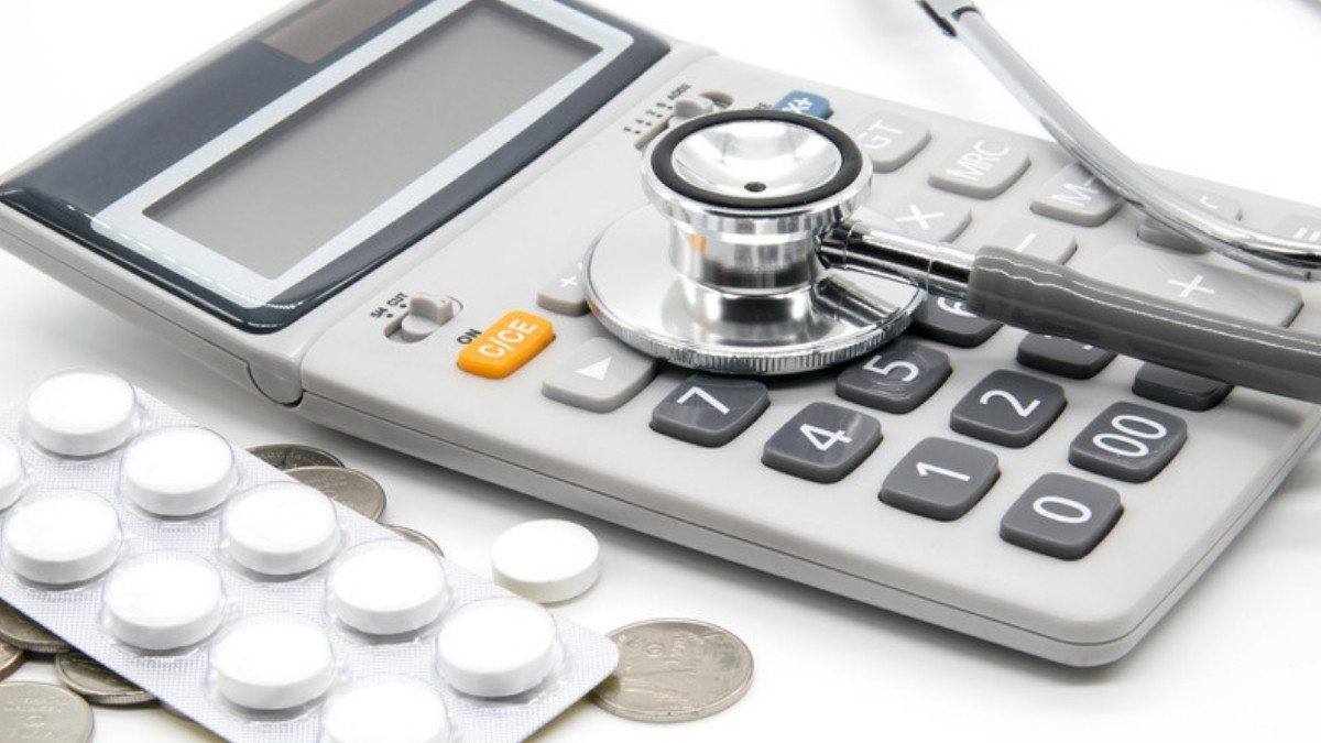 A stethoscope rests on a calculator beside a blister pack of pills, a reminder of the medical costs one wreck can leave behind