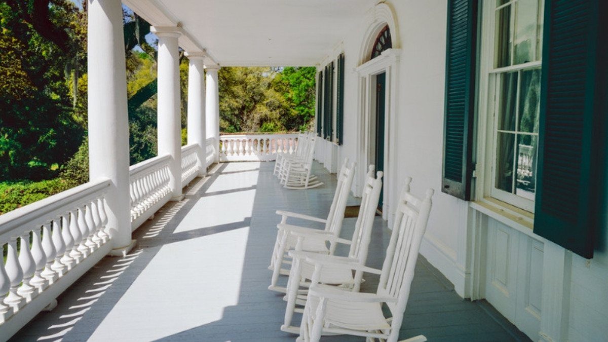 White rocking chairs line a quiet, sunlit porch, a calm place to think about the next stage of a car accident case