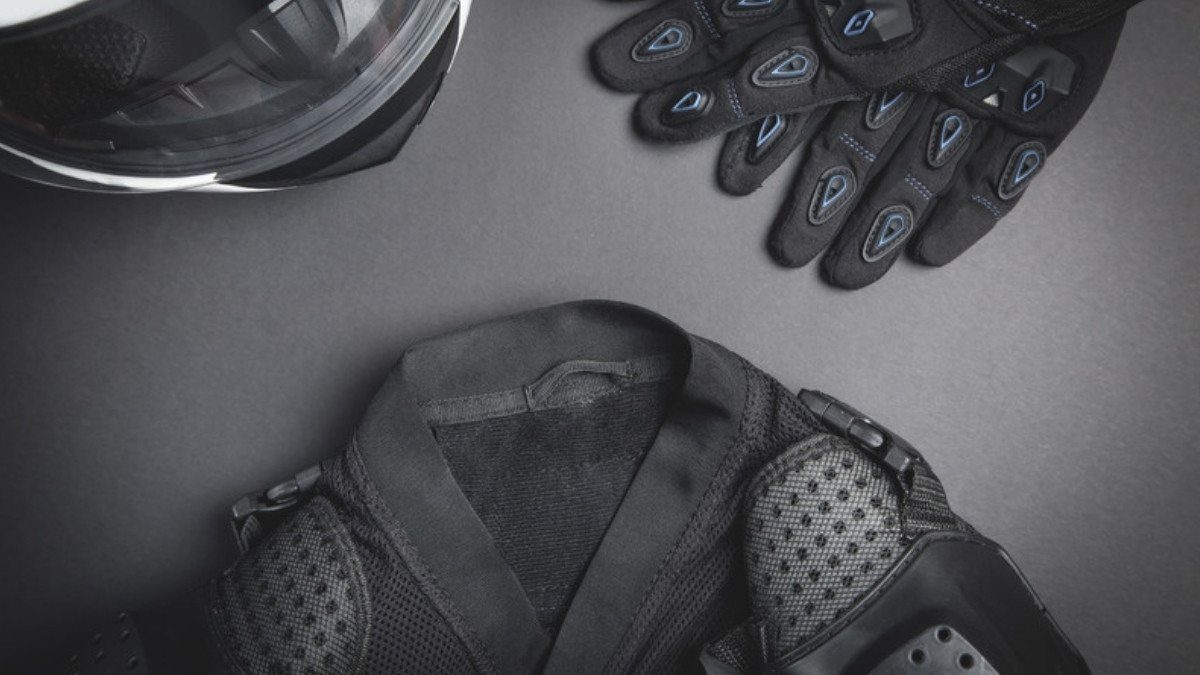 A helmet, armored gloves and a padded riding jacket lie together, gear motorcycle accident attorneys in Summerville count in a claim