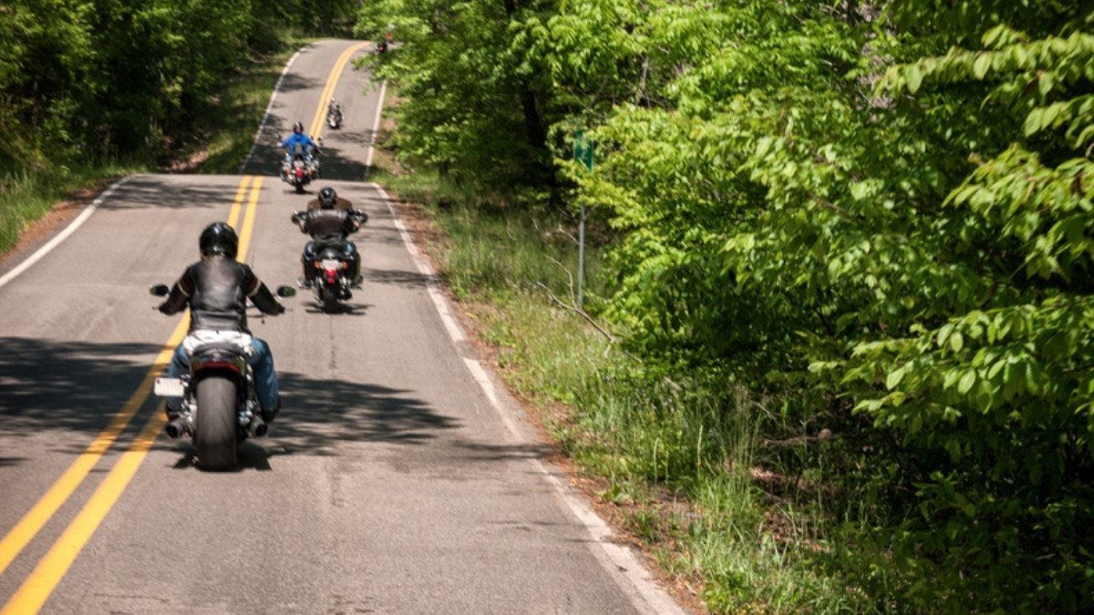 Riders hold their lane on a wooded road with double yellow lines, lane rights motorcycle accident attorneys in Summerville explain