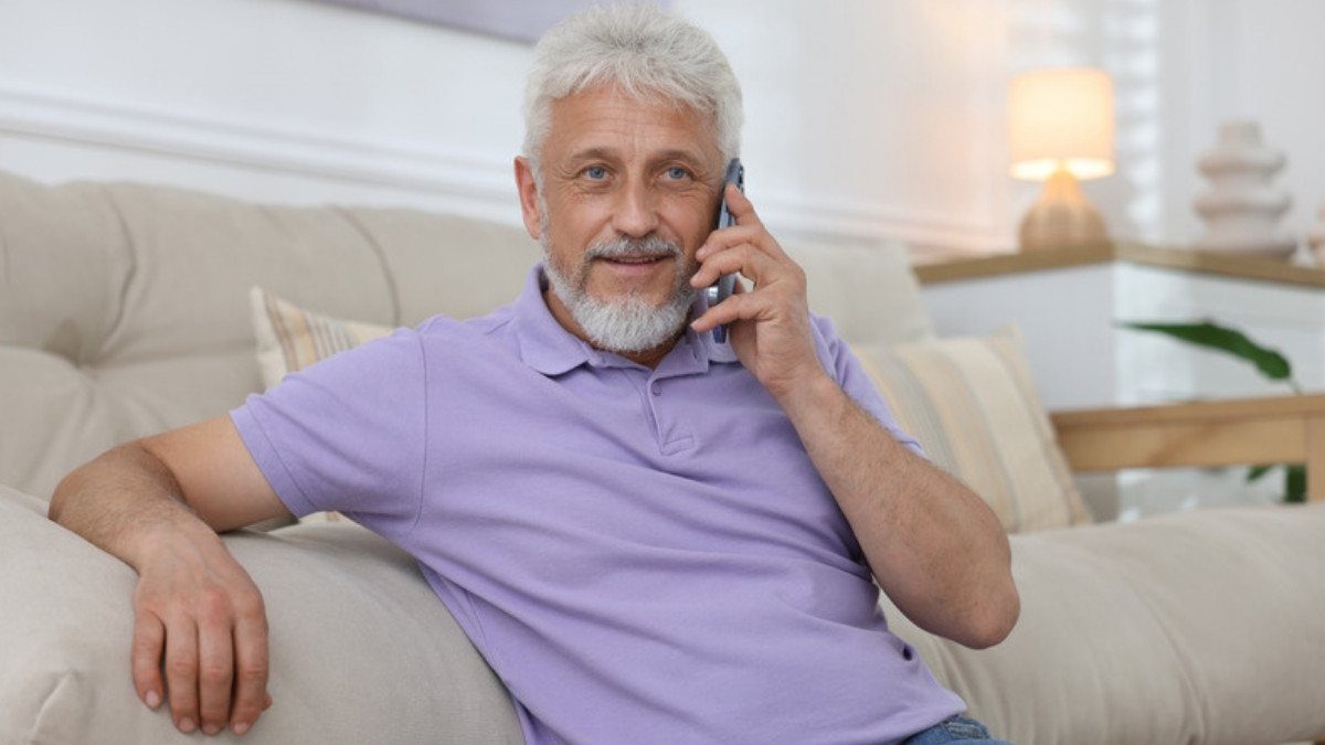 A silver haired man leans back on his couch for a phone call, an easy start with motorcycle accident lawyers in Berkeley County