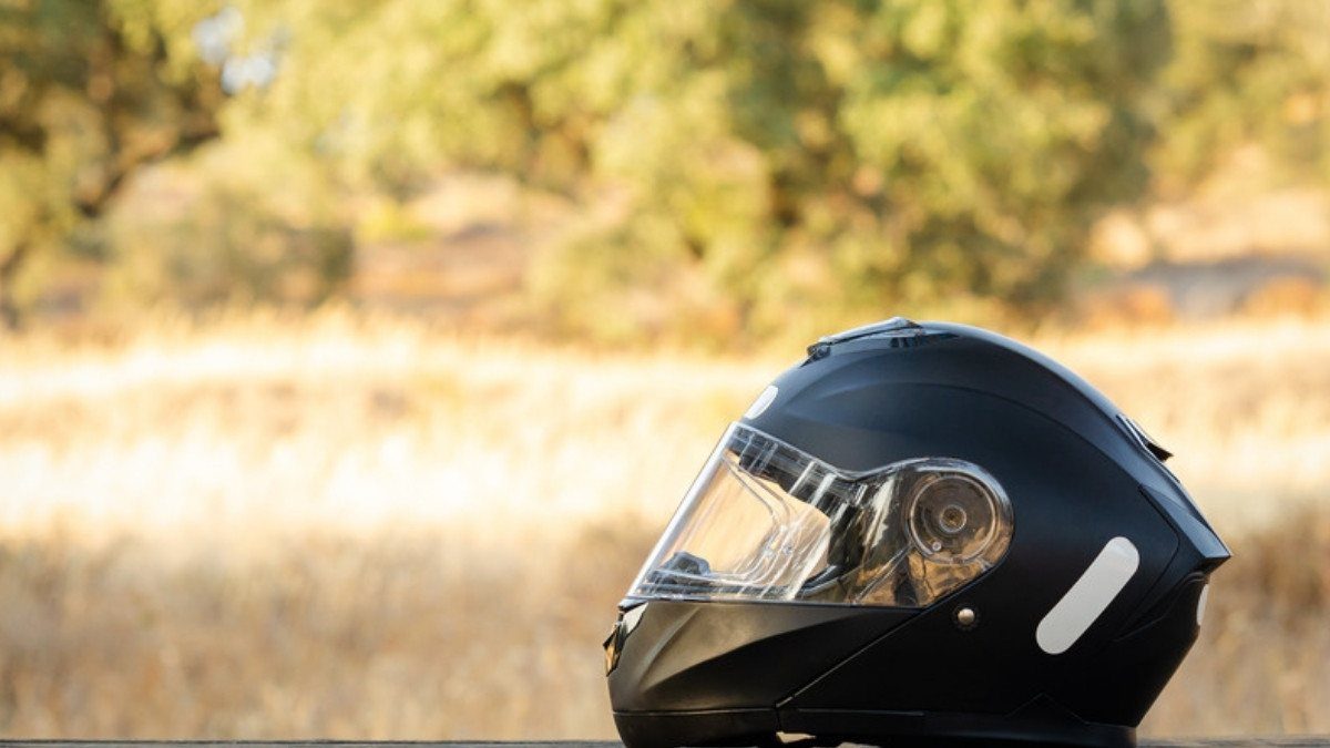 A black helmet rests on a rail in golden light, a quiet pause for riders who call motorcycle accident lawyers in Charleston County
