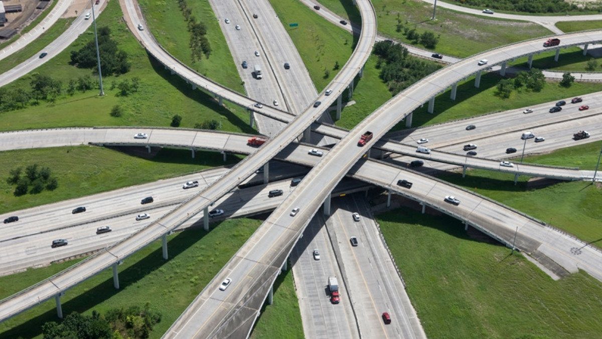 Flyover ramps cross a busy highway interchange with traffic on every level, a merge North Charleston personal injury lawyers study