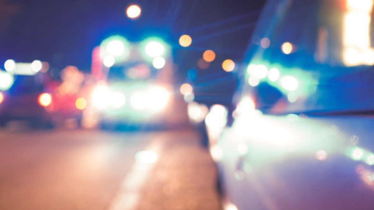 Blurred ambulance lights move through night traffic, often the start of a transfer personal injury attorneys in Beaufort County trace