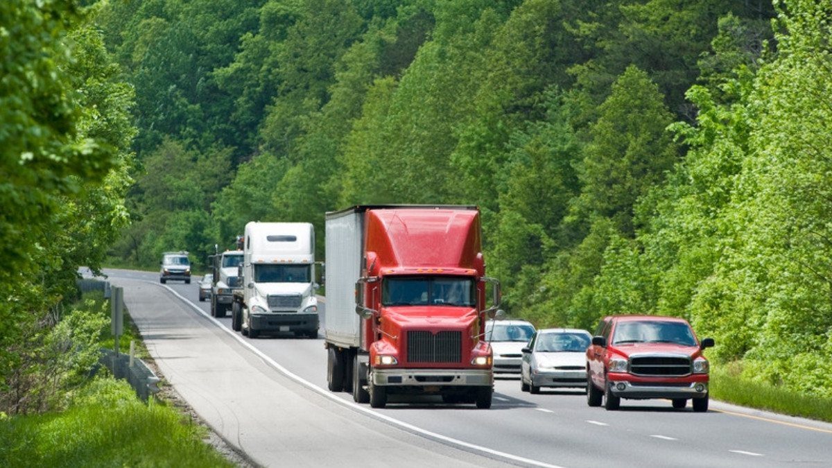 Semi trucks, a pickup and cars share a wooded highway, the mix of crash claims personal injury attorneys in Berkeley County take on