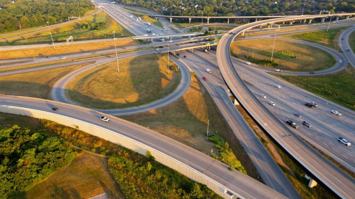Curving ramps loop through a highway interchange in evening light, a junction personal injury attorneys in Charleston County study