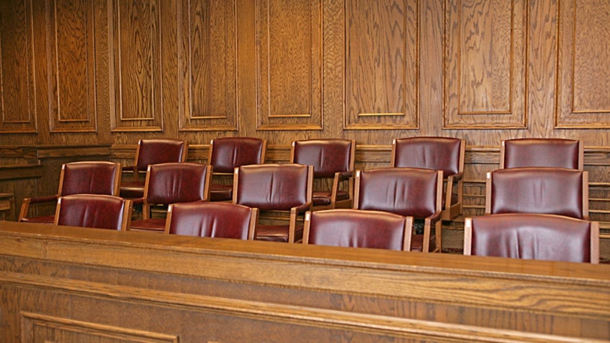 Empty red leather chairs fill a wood paneled jury box like the ones personal injury attorneys in Williamsburg County see in court