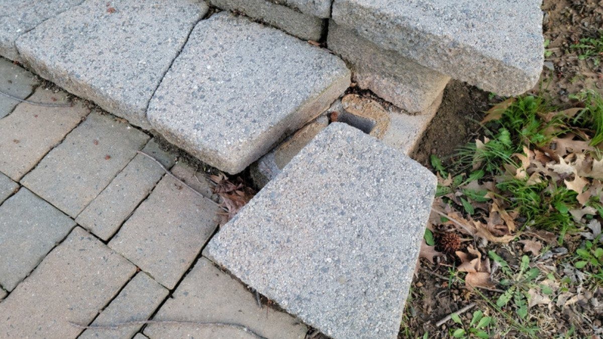 A loose paver has pulled away from an outdoor step, the kind of hazard premises liability lawyers in Summerville document