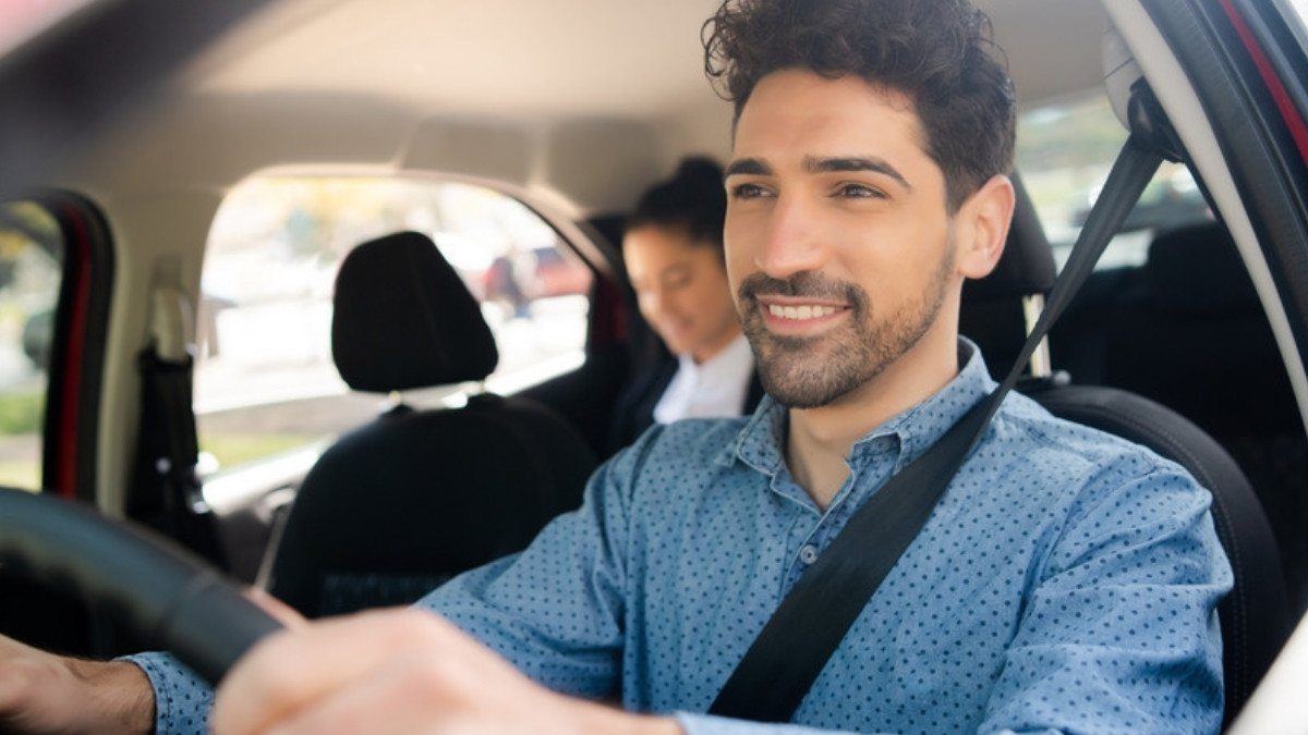 A driver steers while a passenger sits in the back seat, the kind of trip rideshare accident attorneys in Summerville look at first