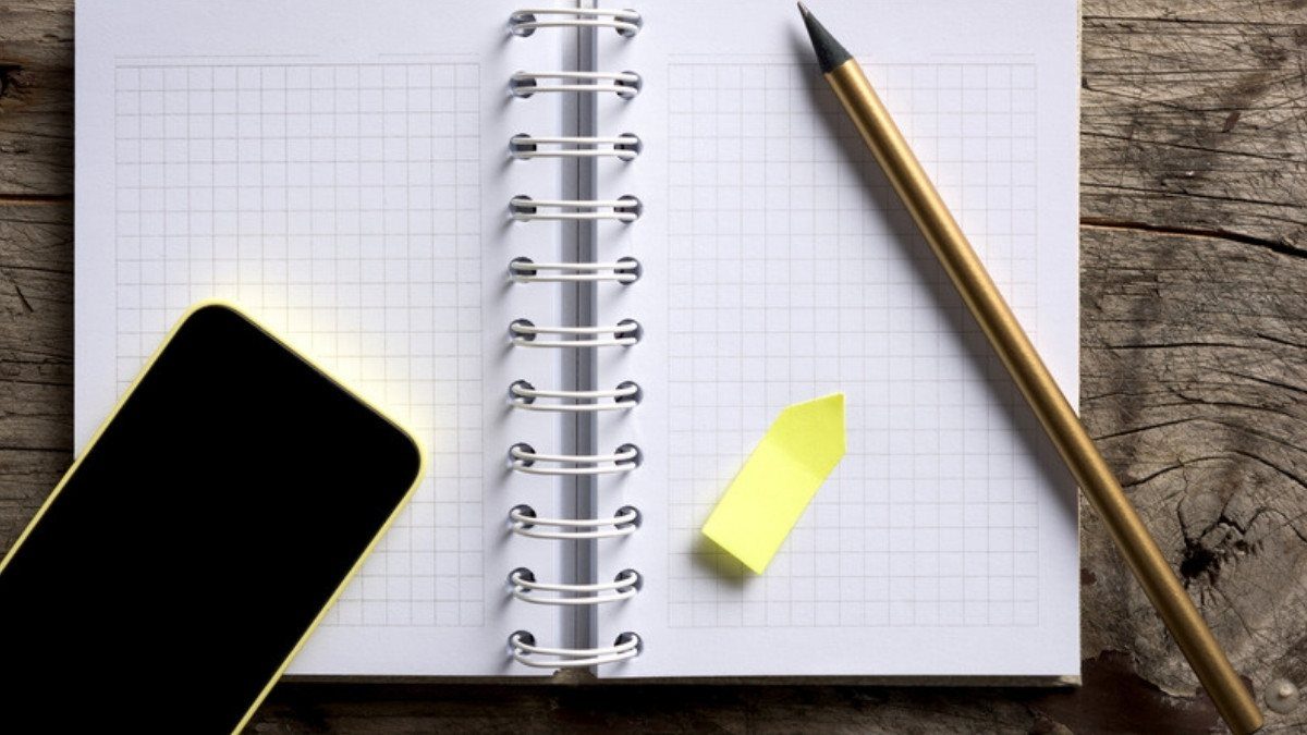 A phone, a pencil and an open notebook rest on a weathered table, ready for jotting down a statute of limitations date