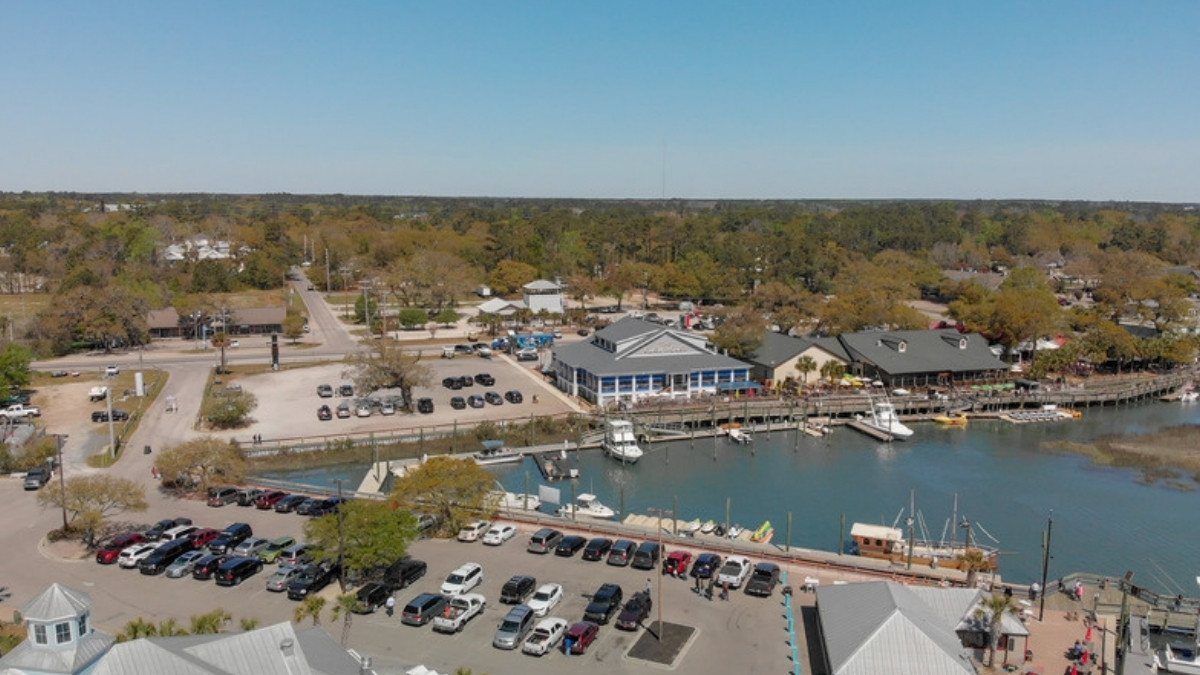 Boats line the marina along the harborwalk in Georgetown, South Carolina, seen from above on a bright spring day