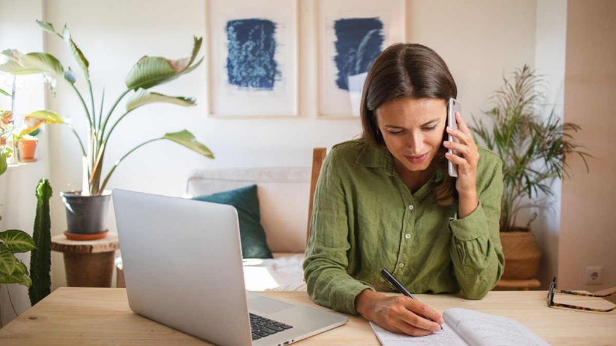 Phone in hand, a woman takes notes at home, the kind of record keeping that helps when a crash was not your fault