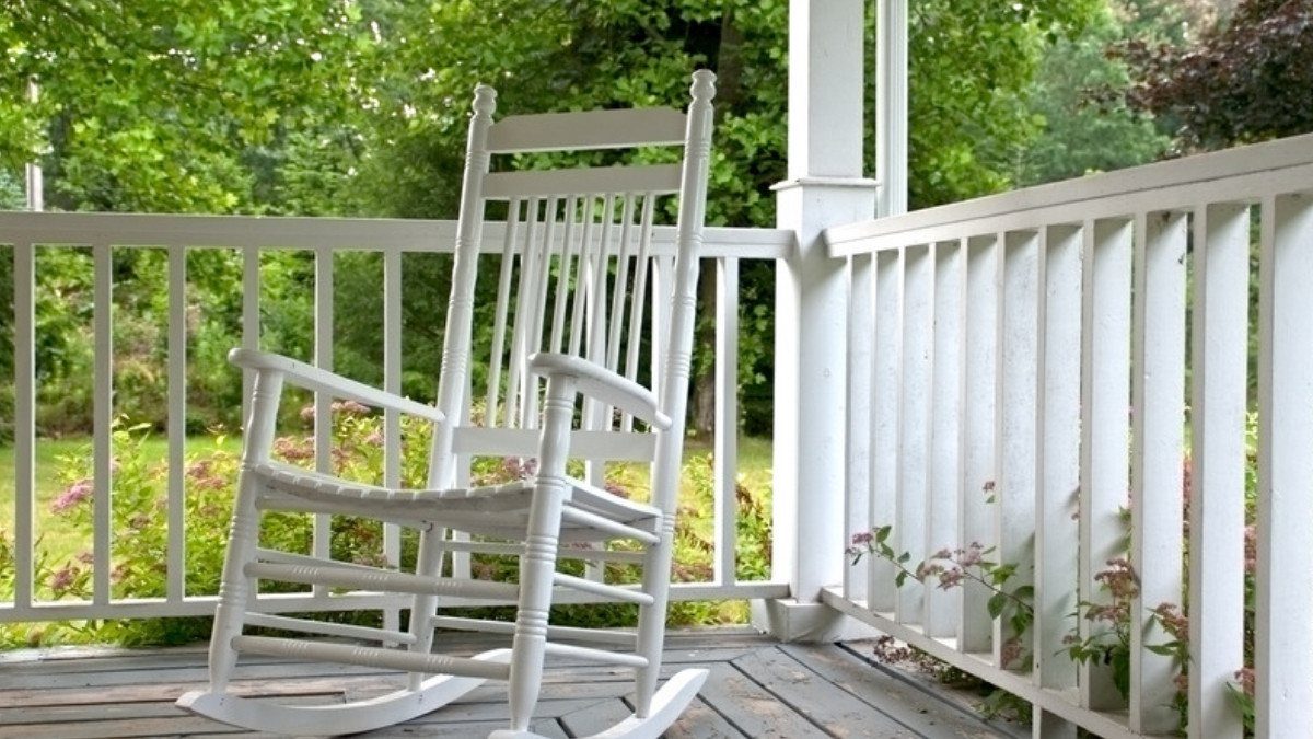 An empty white rocking chair rests on a shaded porch, the lost companionship wrongful death attorneys in Summerville try to measure