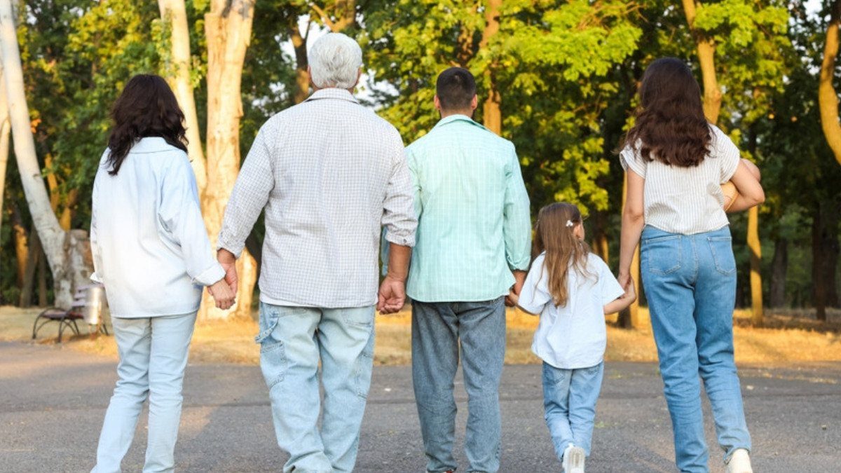 Three generations walk hand in hand down a park path, the relatives wrongful death attorneys in Summerville ask about first